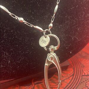 Lanyard with a hand tag notating HH and a lotus, stainless steel w/ lovely chain